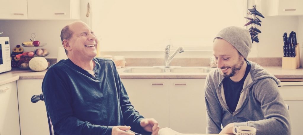 Friends laughing together in an accessible home.