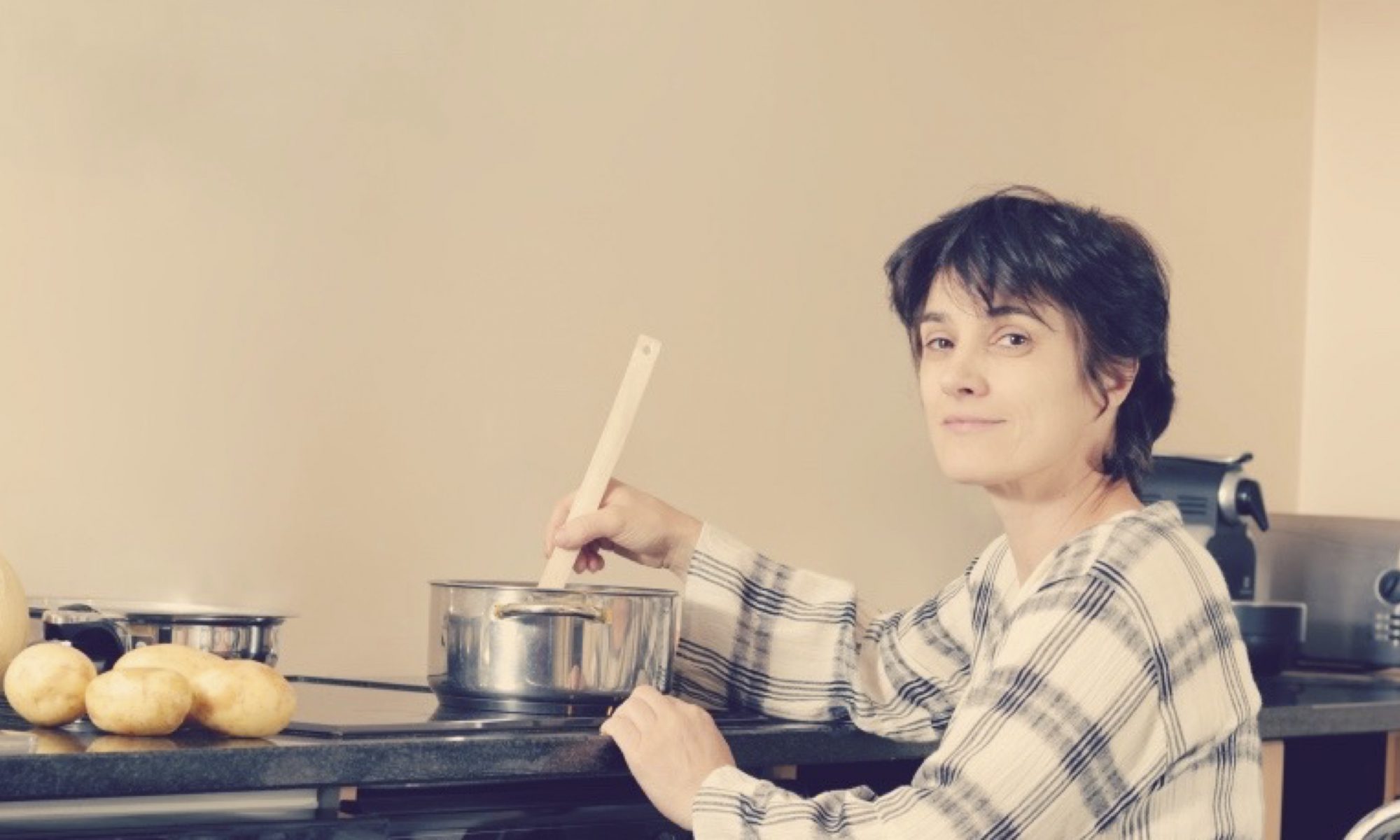 Lady in wheelchair cooking in accessible kitchen